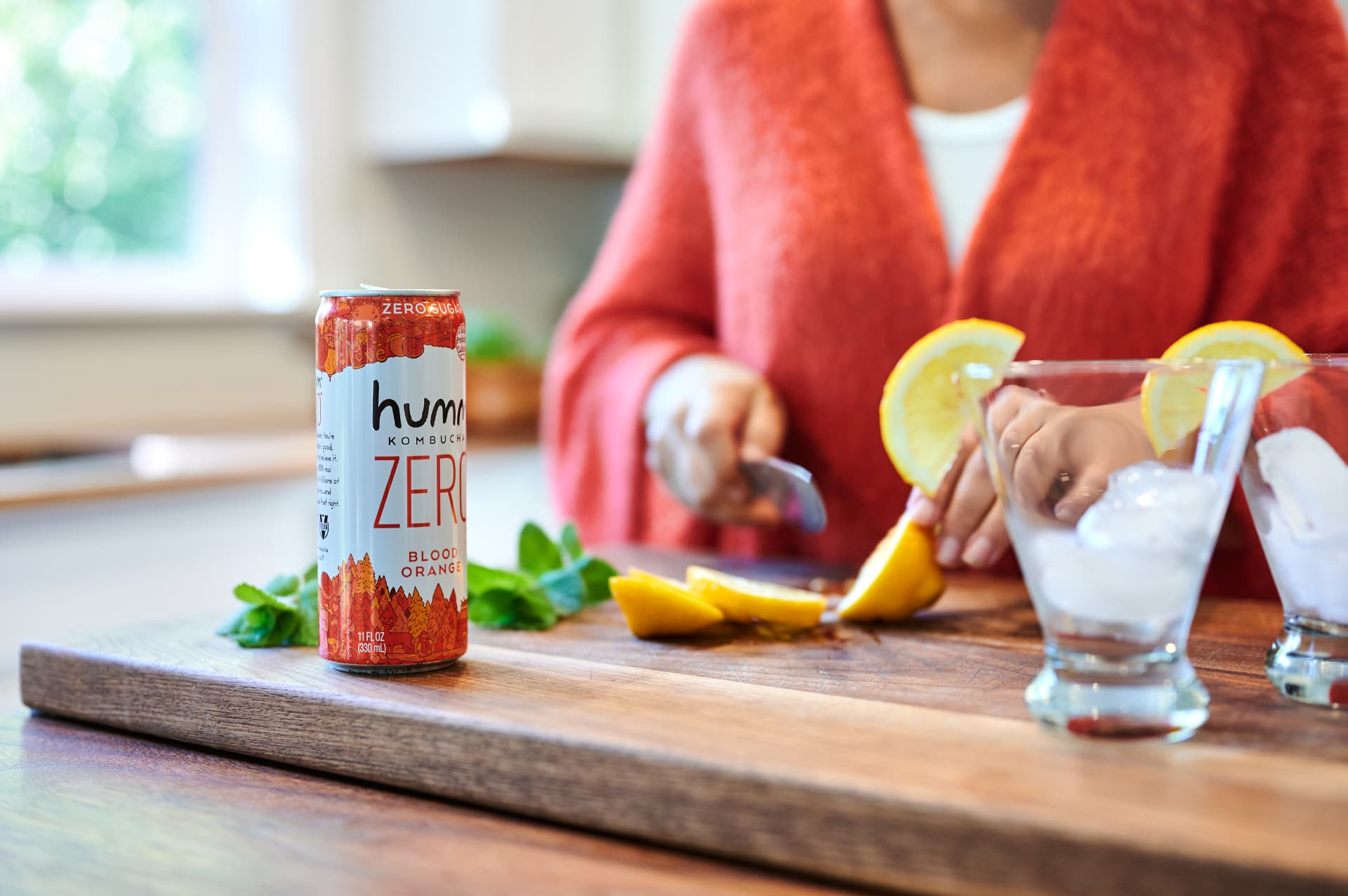 Humm Zero Blood Orange can with citrus and mint on a wood board