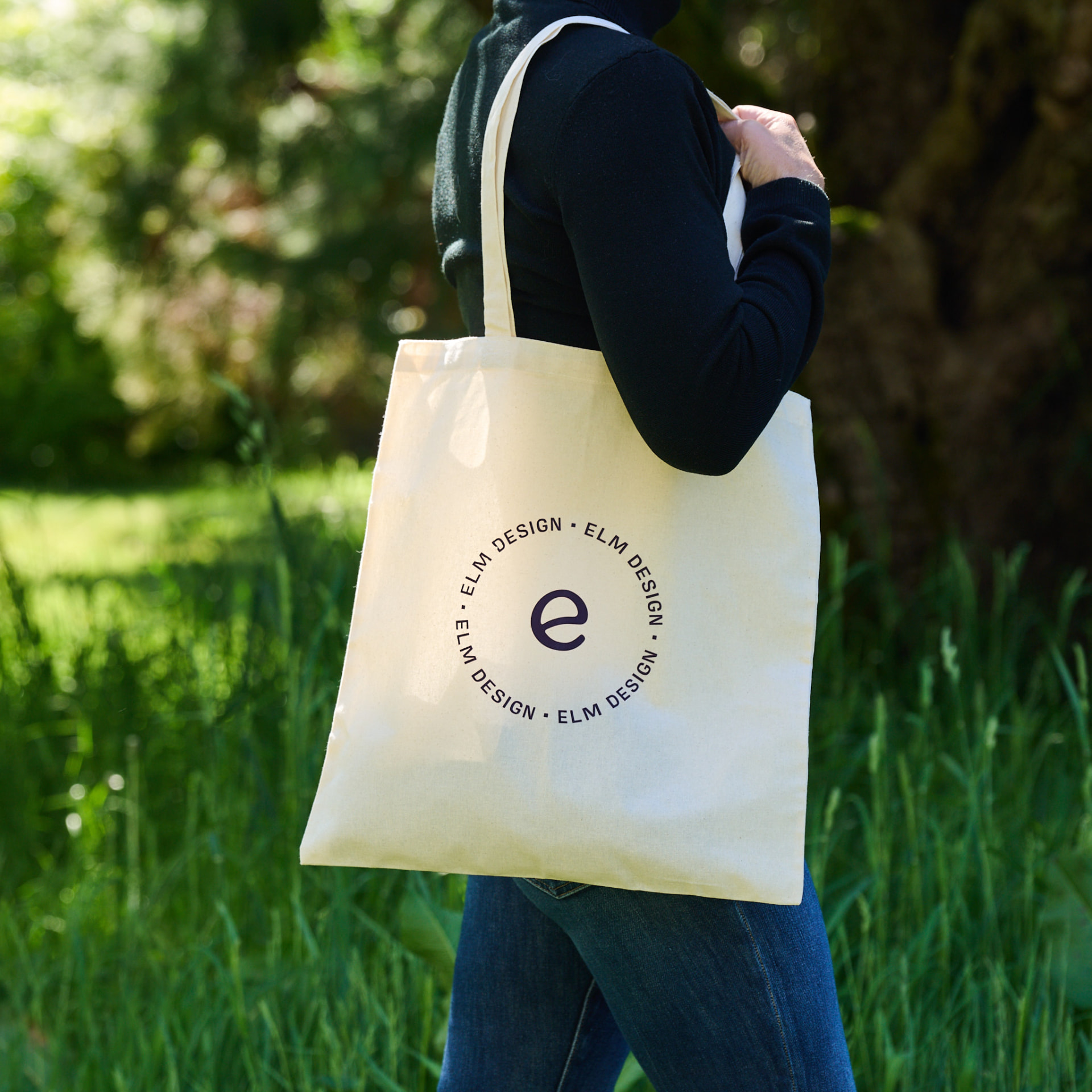 Elm Design branded canvas tote carried outdoors